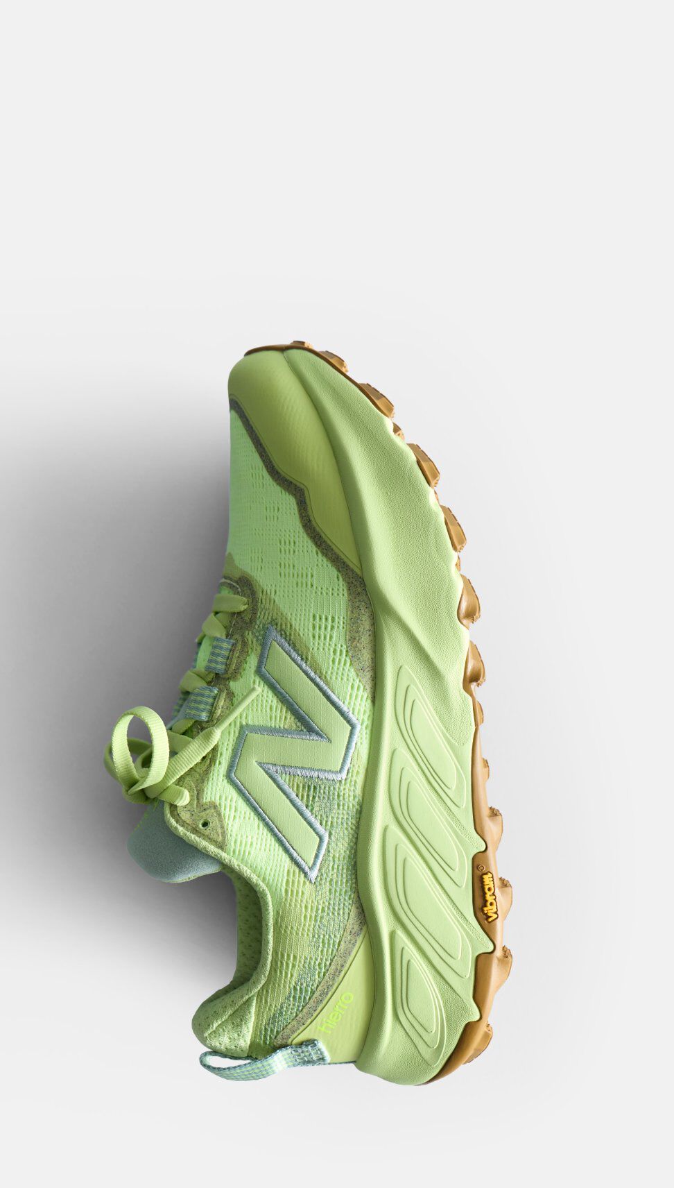 Light green sneaker with a thick sole and a New Balance logo, shown on a white background
